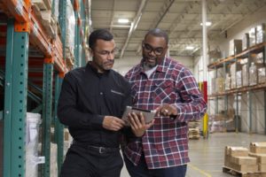 2 guys looking at a tablet